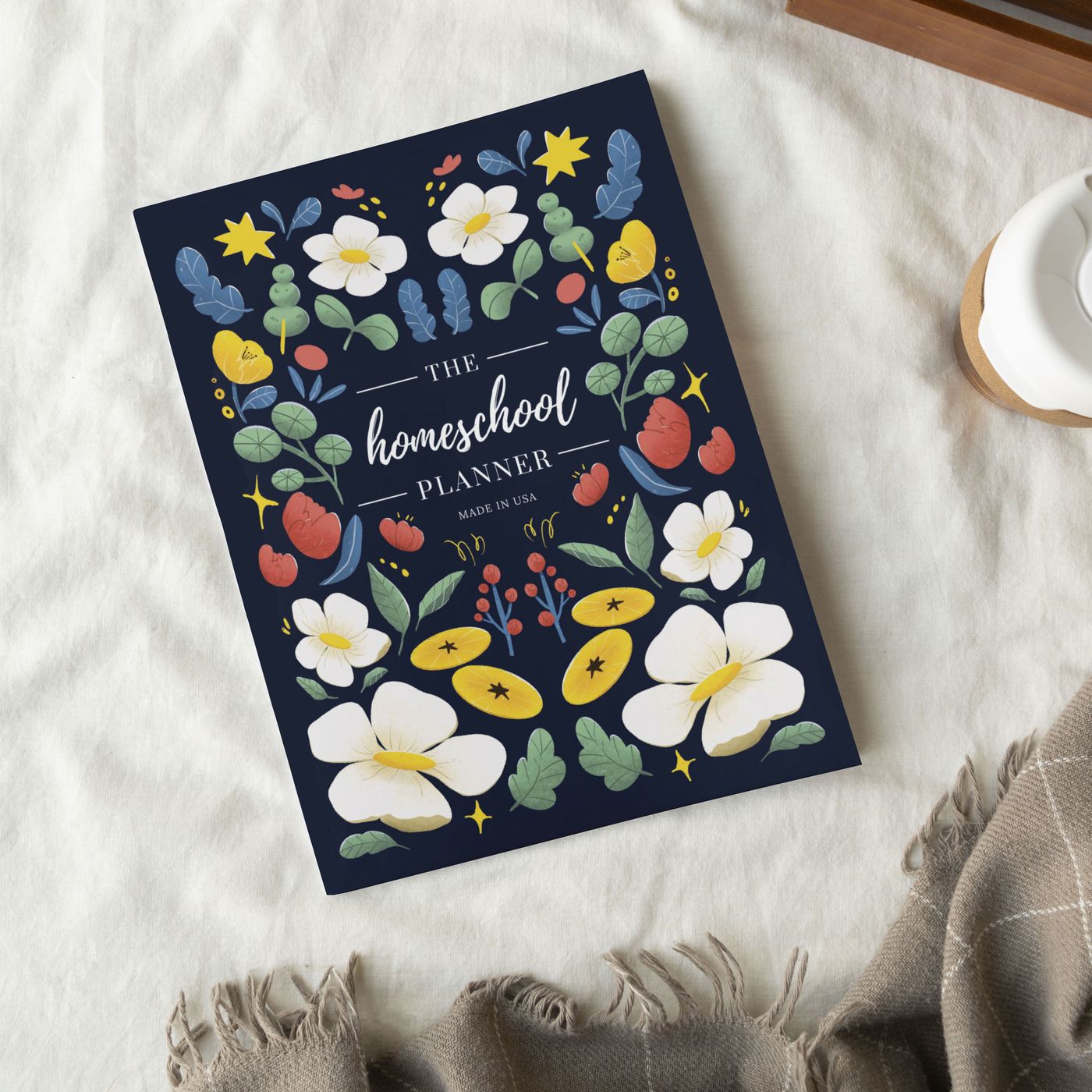 The Homeschool Planner on a white blanket