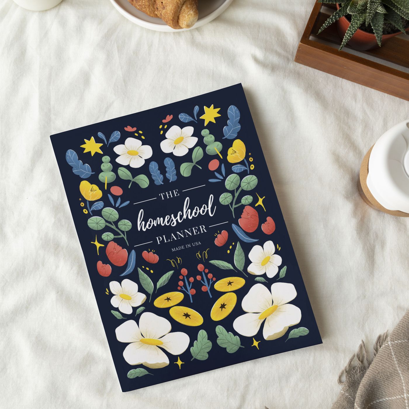 The Homeschool Planner styled with a coffee and pastries