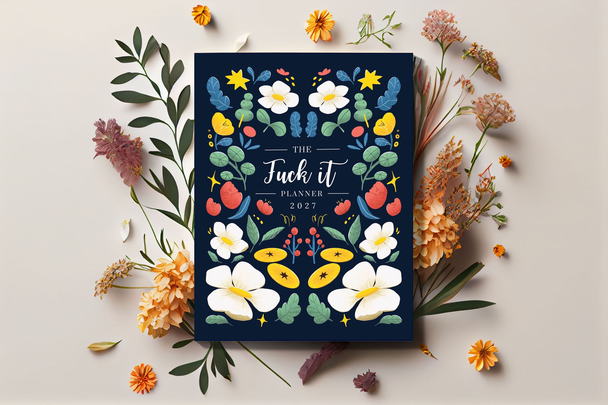 The Fuck It Planner 2027, navy floral cover, among dried flowers